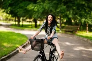 Woman riding bicycle, enjoying hobby